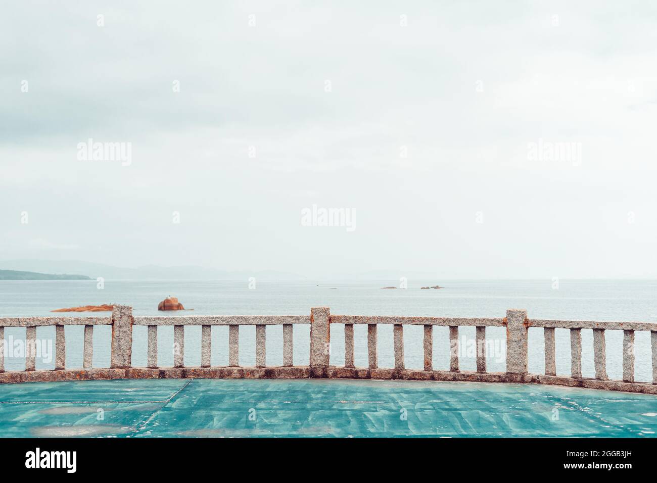 Viewpoint to the ocean with a railing made of granite stone Stock Photo ...