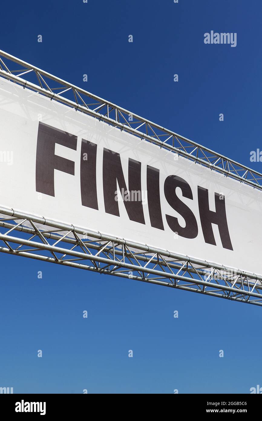 Finish line signage in metal frame isolated against a clear blue sky background Stock Photo