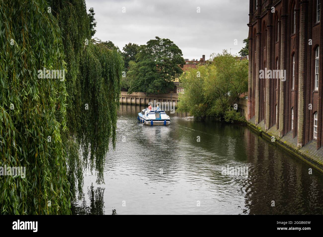 A view of the river Wensum from St Georges bridge norwich with a hire cruiser going down river Stock Photo
