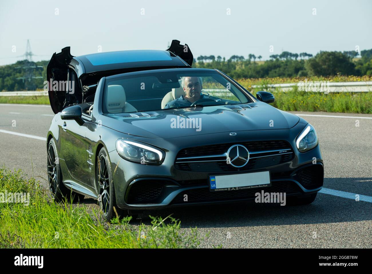 Dnepropetrovsk, Ukraine - 08.24.2021: Photos of a Mercedes Benz SL550 convertible on the road. Conversion of a sedan into a convertible. Stock Photo