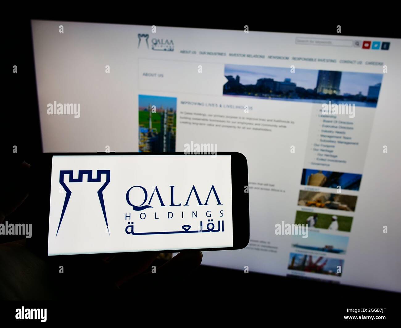 Person holding mobile phone with logo of Egyptian investment company