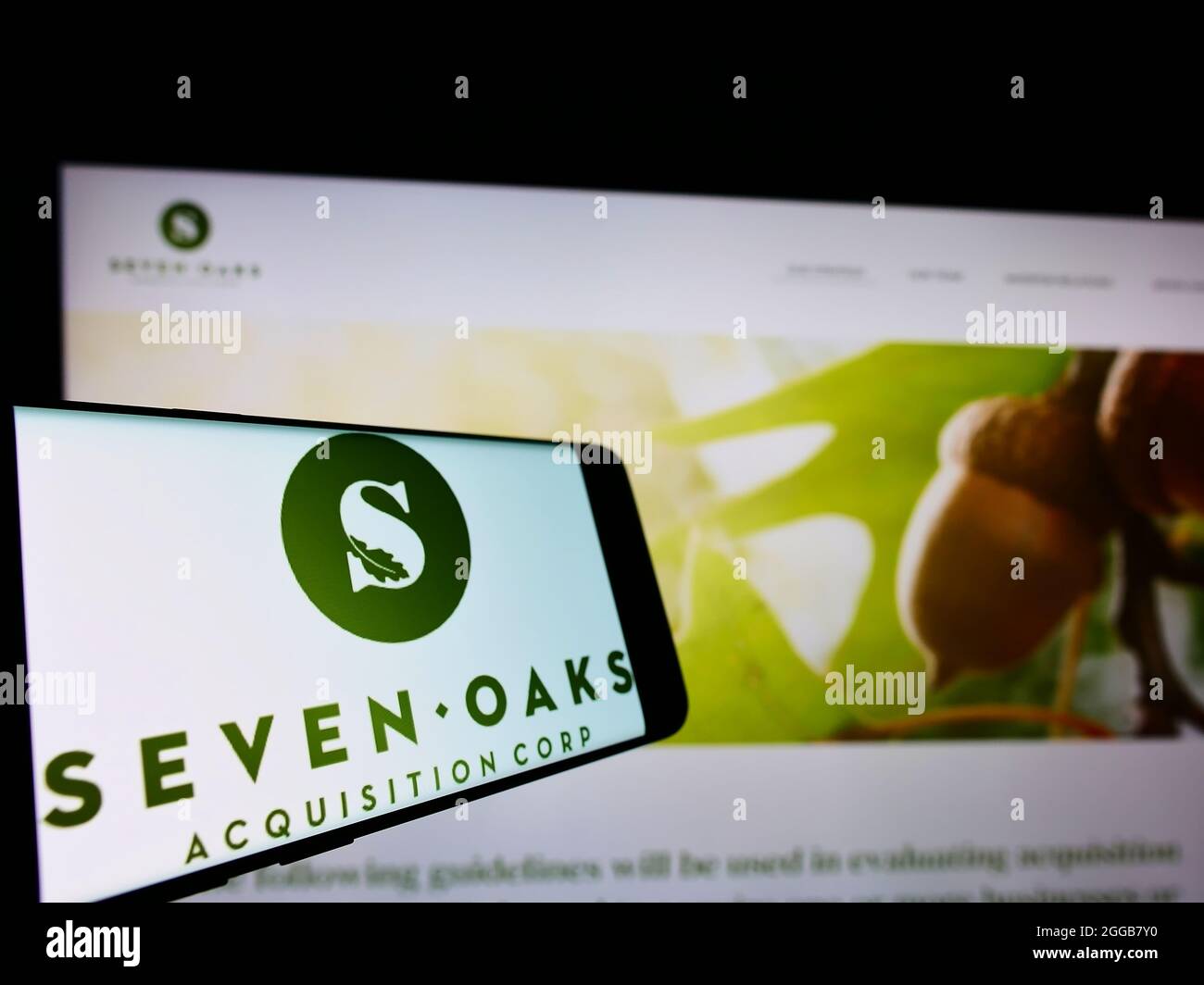 Smartphone with logo of American company Seven Oaks Acquisition Corp. on screen in front of business website. Focus on center of phone display. Stock Photo