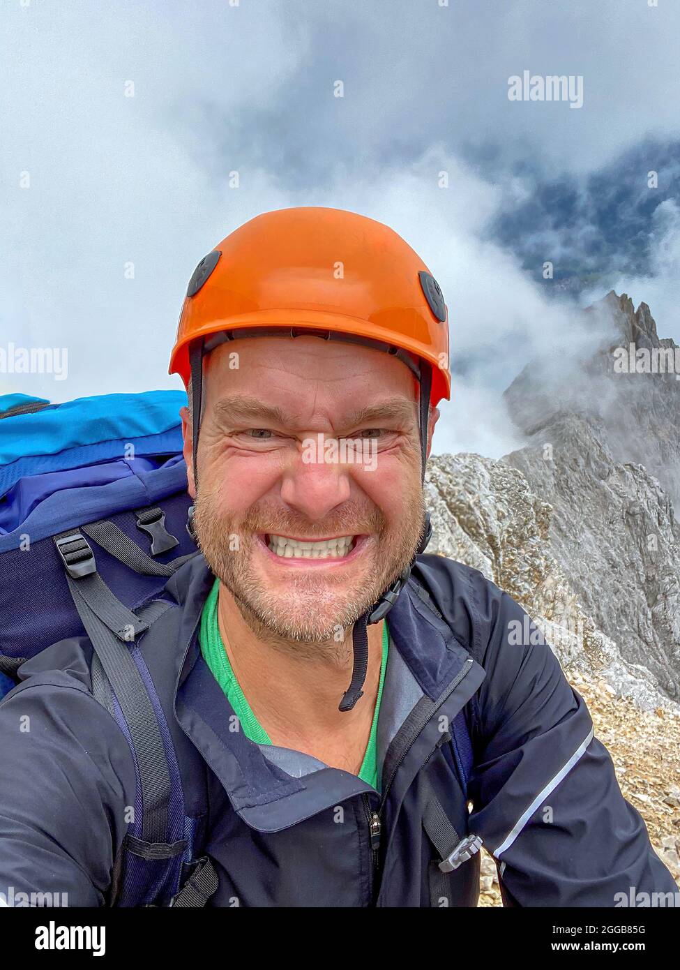Happy Hiker hike up to the peak Stock Photo - Alamy