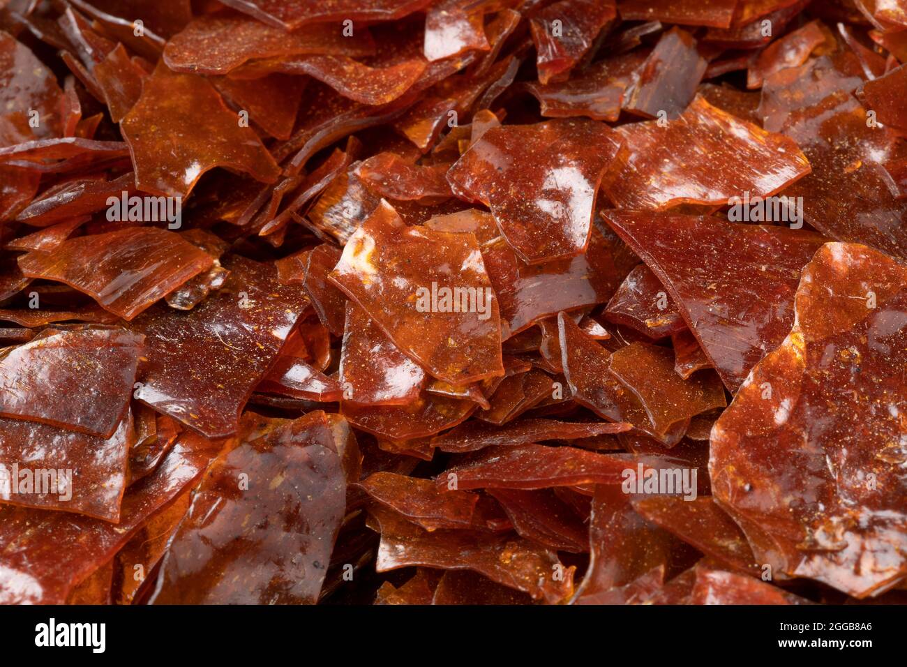 Brown Shellac dry flakes close up full frame as background Stock Photo