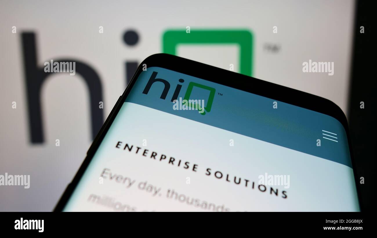 Mobile phone with webpage of American data science company hiQ Labs Inc. on screen in front of business logo. Focus on top-left of phone display. Stock Photo