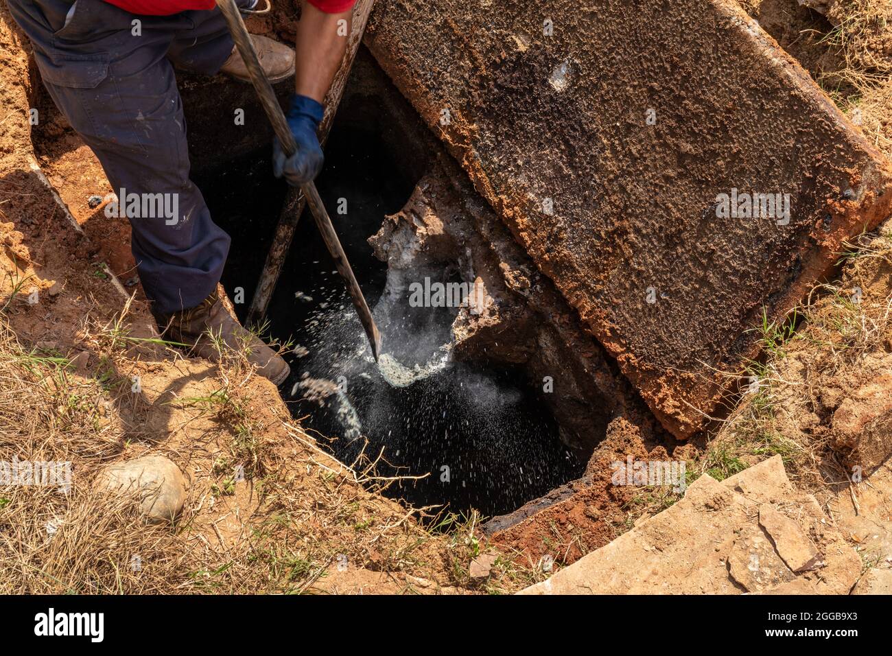 Breaking up aged concrete wastewater outlet in an old septic tank