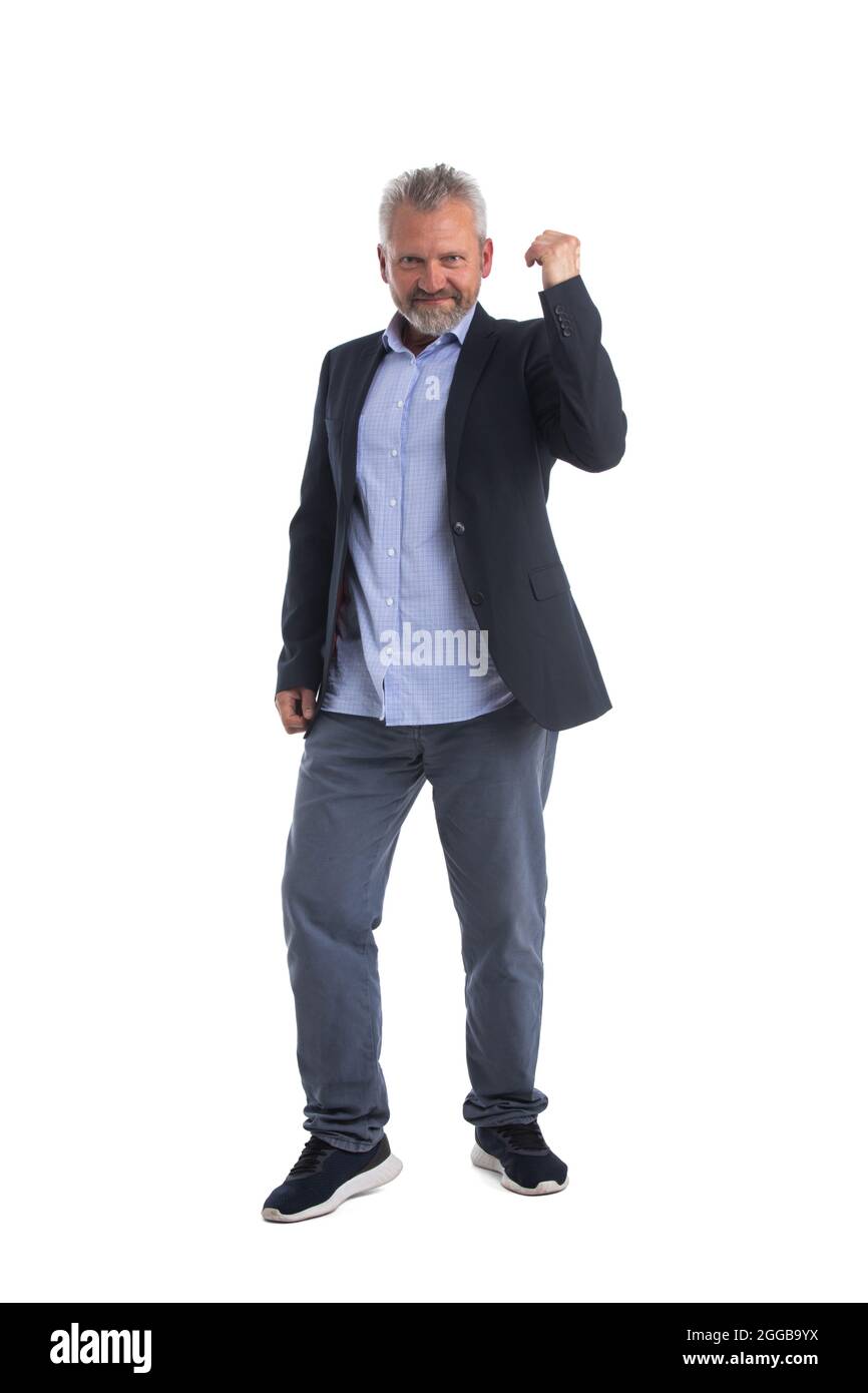 Senior businessman cheering his success raising fist in the air as he ...