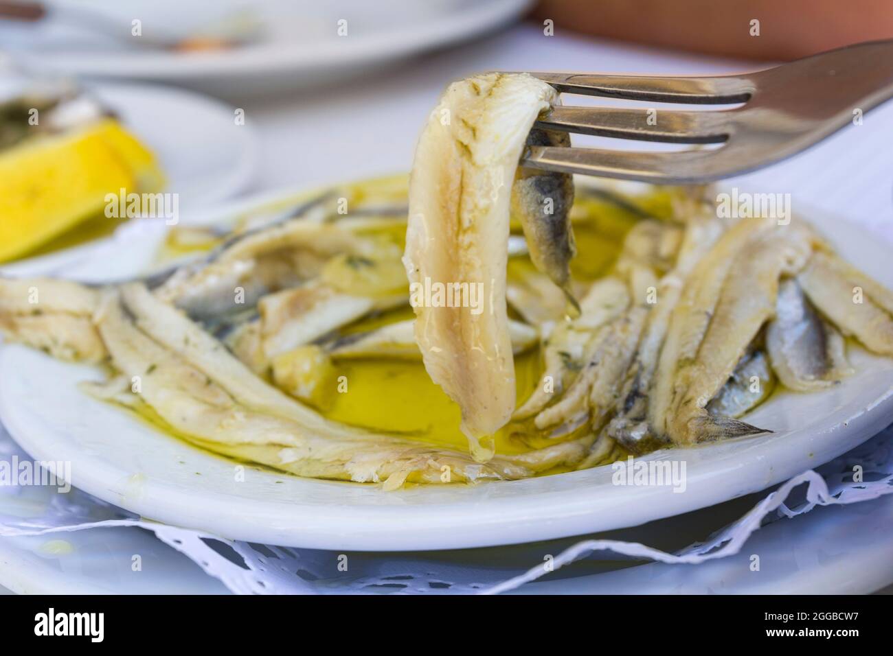Plate with fish fillet in olive oil and vinegar Stock Photo Alamy