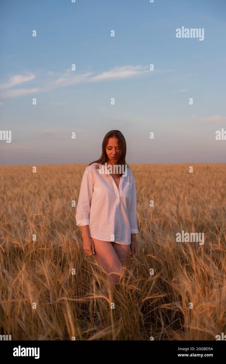 Aerial view of woman lying in the yellow field of wheat Stock Photo - Alamy