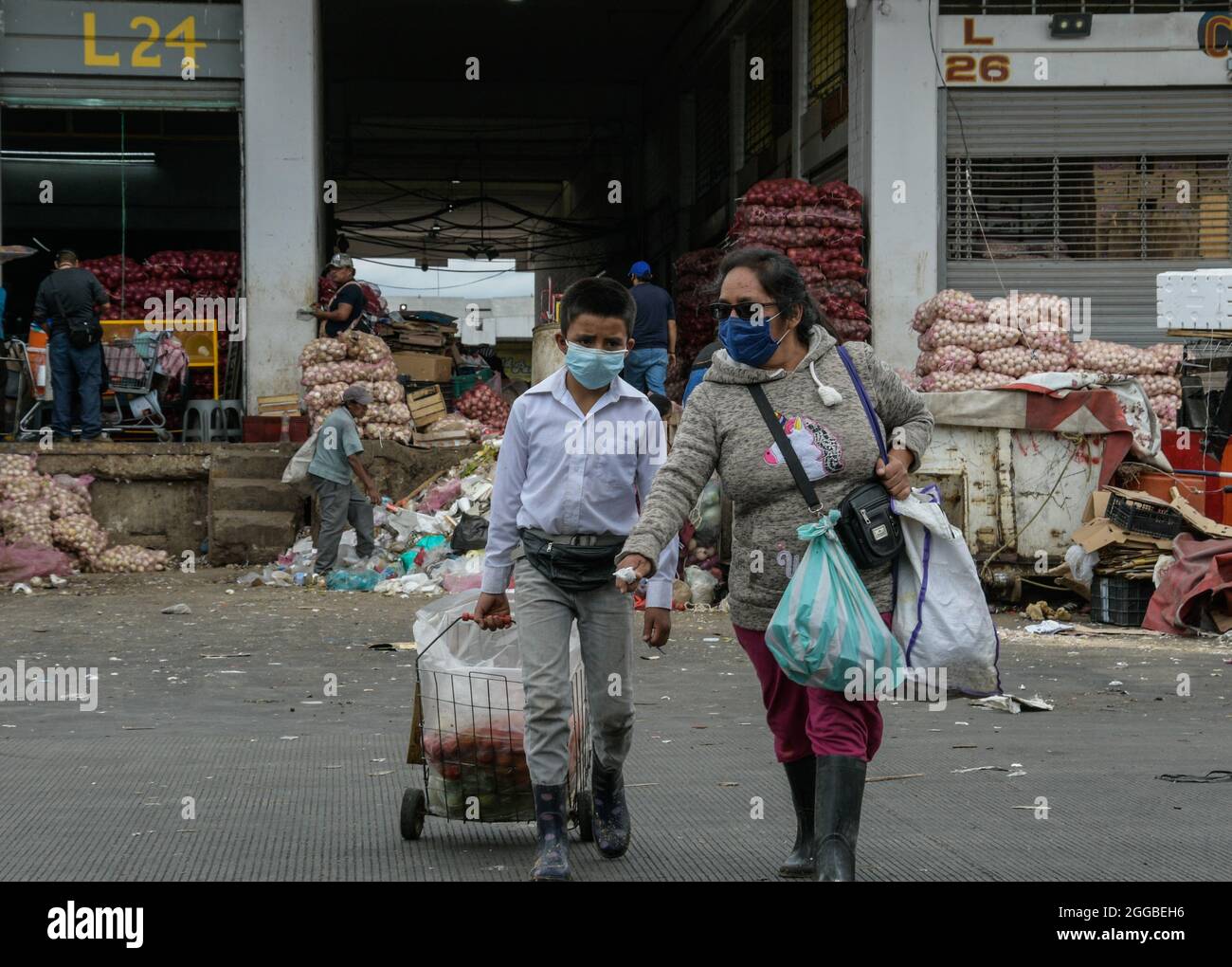 David Solano, 8, and Christian Vazquez, 9, looking for in the garbage  containers of the Central de Abasto, fruit, vegetables and any food that is  in good condition to take it home.