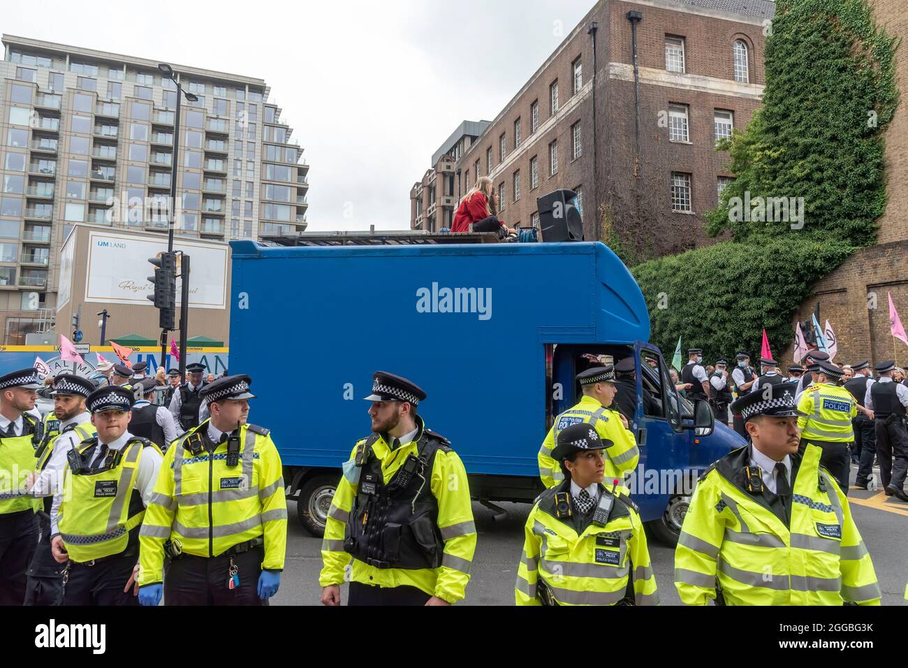 London, UK. 30th Aug, 2021. Police surround a van blocking the road near Tower Bridge with protesters on the roof blocking during the Extinction Rebellion's The Impossible Tea Party protest against the lack of action to the climate crisis. Credit: SOPA Images Limited/Alamy Live News Stock Photo
