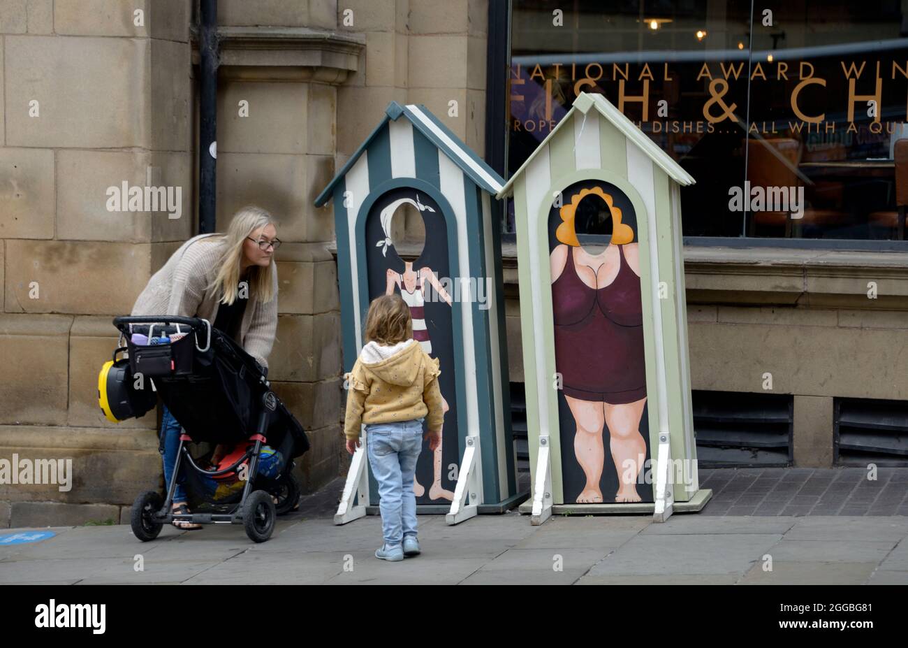 Mother & child, looking at old style type photo booths Stock Photo