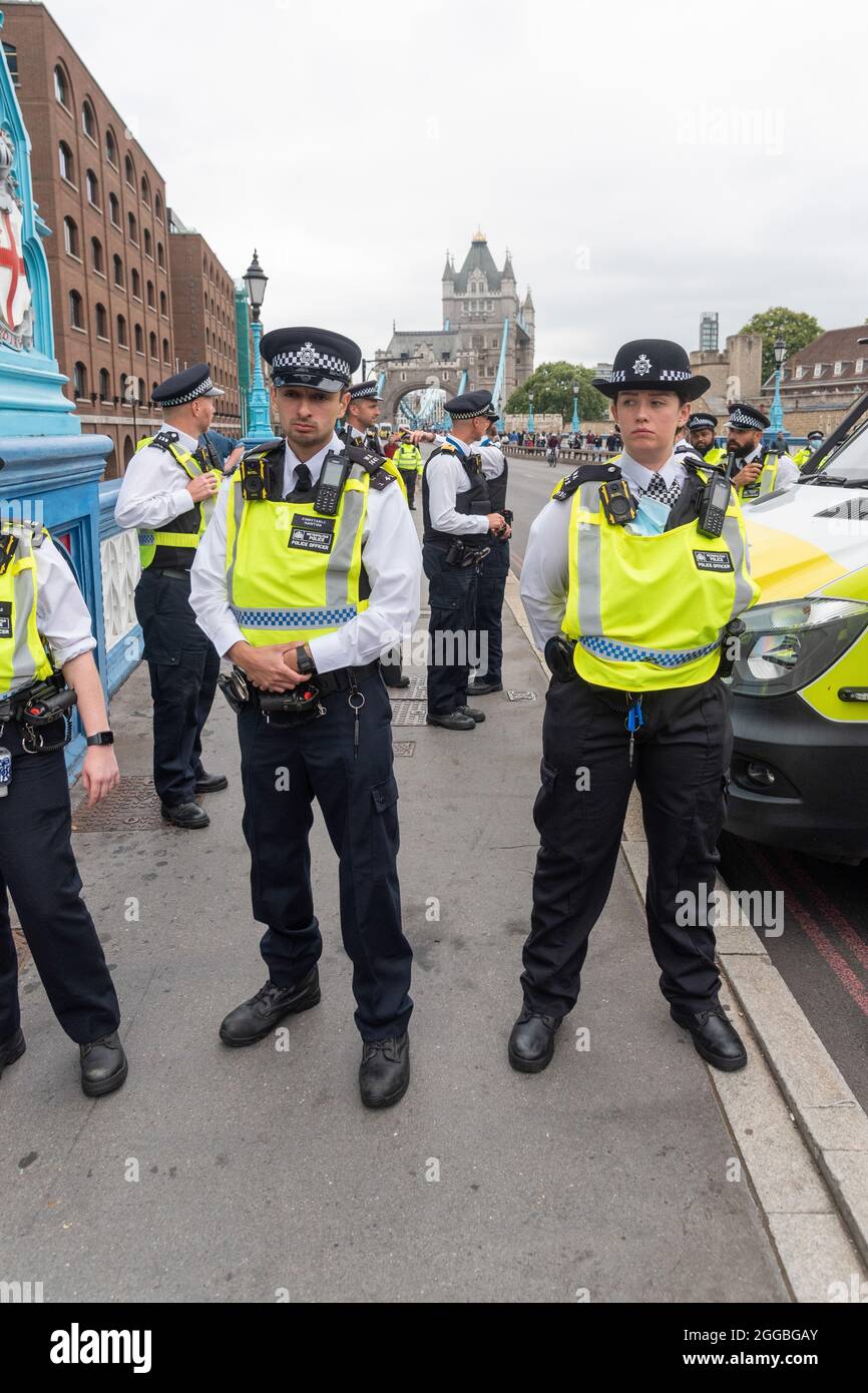 Police officers block access to Tower Bridge in London to restrain ...