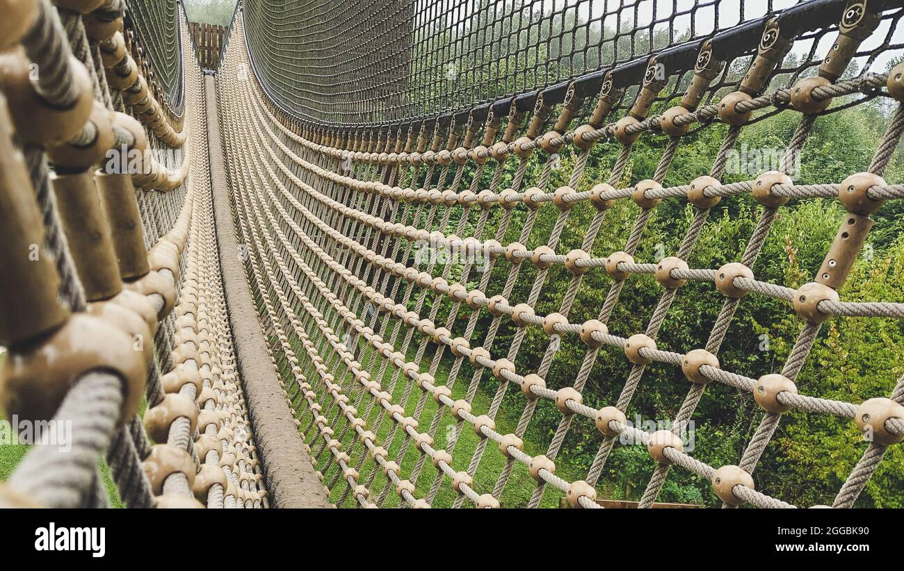 Suspension bridge with rope and mesh nett on a playground for