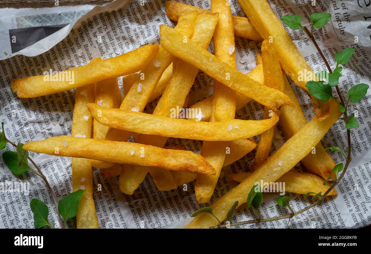 French fries on paper with crumbled feta cheese Stock Photo Alamy