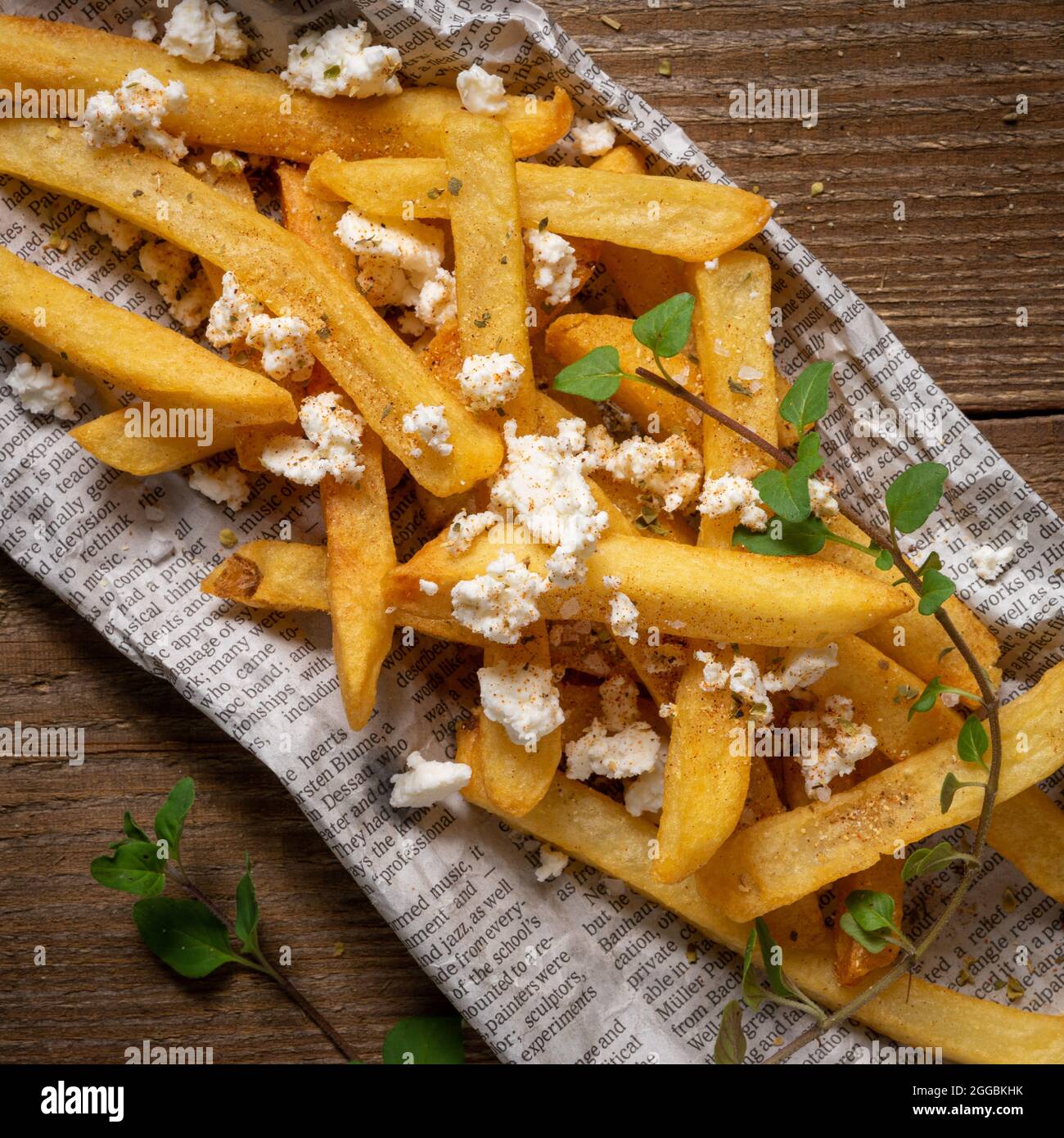 French fries on paper with crumbled feta cheese Stock Photo Alamy