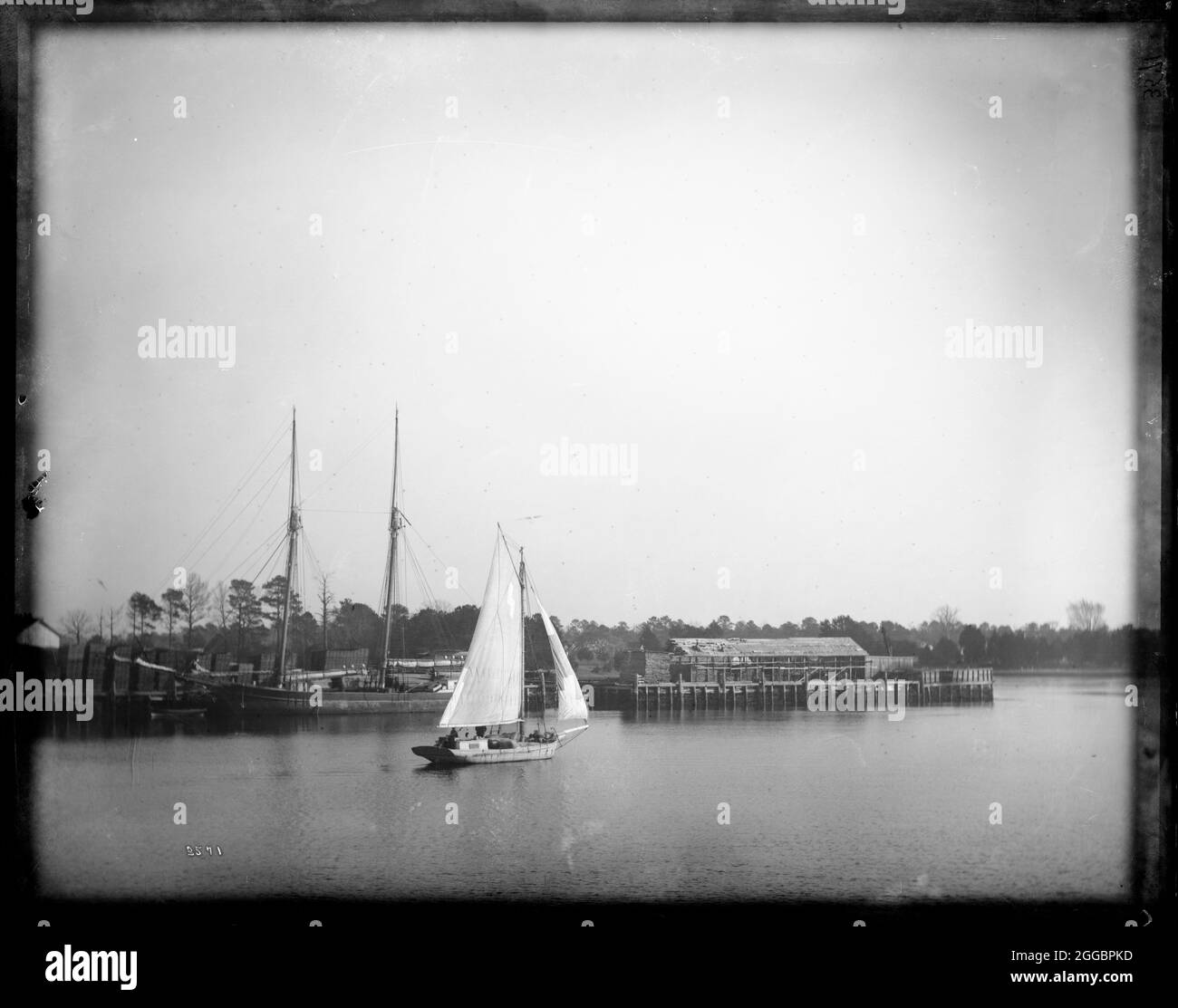 USFC Steamer &quot;Albatross&quot; Survey of the Bahamas, 1886. Sailing vessels, and timber on the dock side. Stock Photo
