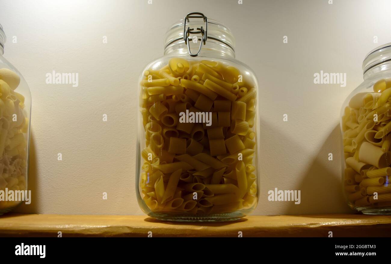 Pasta mix in a glass jar. Cannelloni, Sedani, Mezze maniche and Penne pasta mixed together in one glass jar. Stock Photo