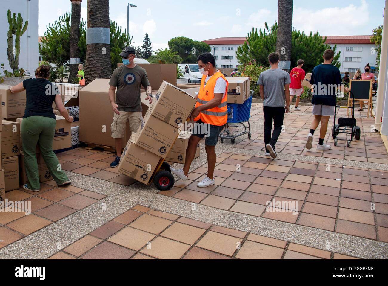 Rota, Spain. 29th Aug, 2021. Volunteers move boxed donations for Operations Allies Refuge to support Afghan refugees evacuated from Kabul August 29, 2021 in Rota, Spain. NAS Rota is providing temporary lodging for evacuees from Afghanistan as part of Operation Allies Refuge. Credit: Planetpix/Alamy Live News Stock Photo
