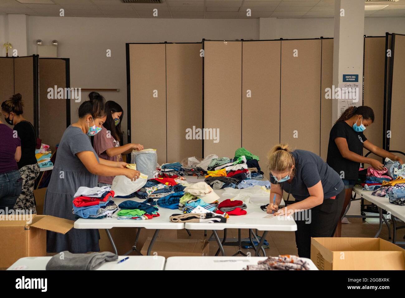 Rota, Spain. 29th Aug, 2021. Volunteers sort clothing donations for Operations Allies Refuge to support Afghan refugees evacuated from Kabul August 29, 2021 in Rota, Spain. NAS Rota is providing temporary lodging for evacuees from Afghanistan as part of Operation Allies Refuge. Credit: Planetpix/Alamy Live News Stock Photo