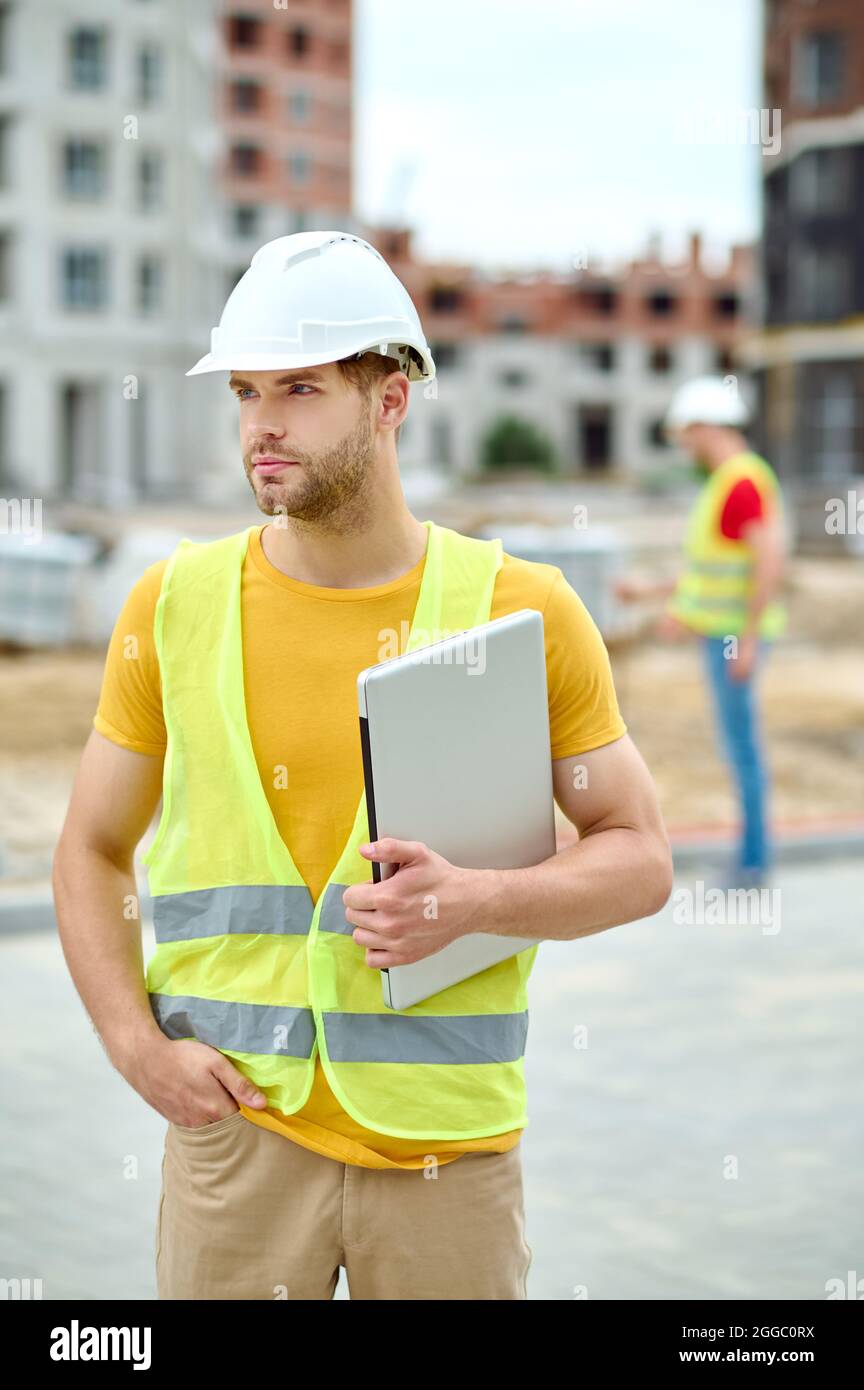 Attractive engineer in a protective helmet looking away Stock Photo