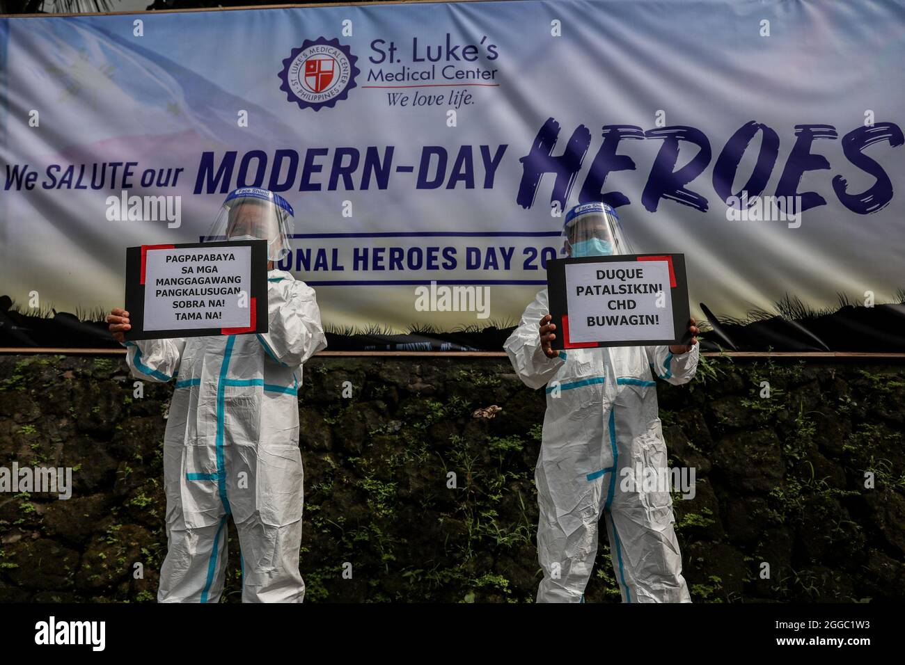 Metro Manila, Philippines. 30th August 2021. Healthcare workers carry signs during a protest to mark National Heroes Day outside the St. Luke's Medical Center in Quezon City. The group called on the government to release funds for benefits and adequate protection for medical workers who continue to be at risk amid the surge of COVID-19 cases in the country. Credit: Majority World CIC/Alamy Live News Stock Photo
