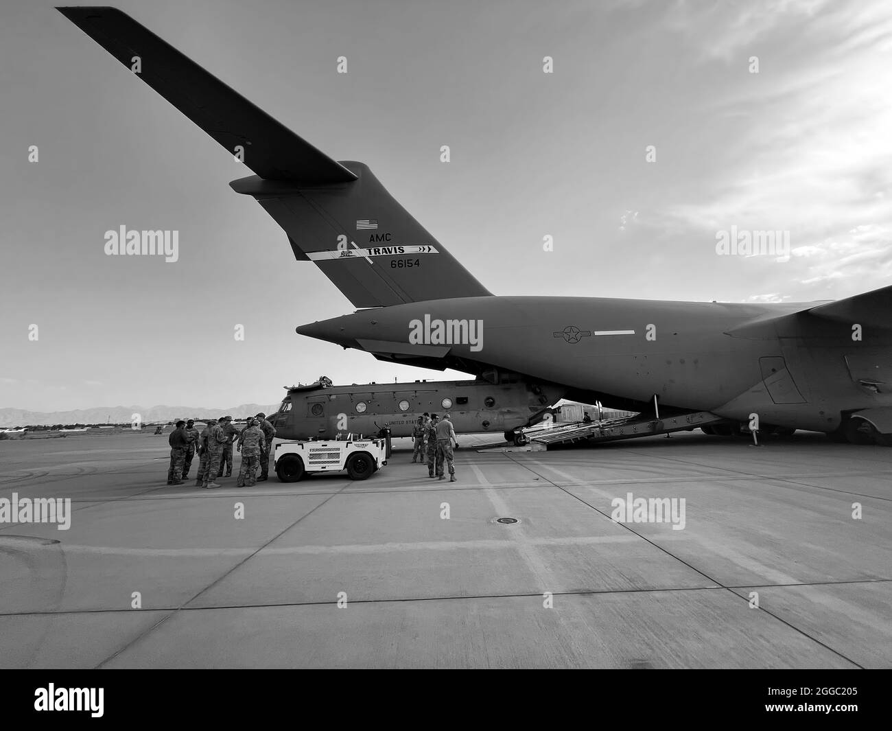 A CH-47 Chinook from the 82nd Combat Aviation Brigade, 82nd Airborne Division is loaded onto a U.S. Air Force C-17 Globemaster III at Hamid Karzai International Airport in Kabul, Afghanistan, August 28. The Chinook. is one of the pieces of equipment returning to the U.S. as the military mission in Afghanistan comes to an end. Stock Photo