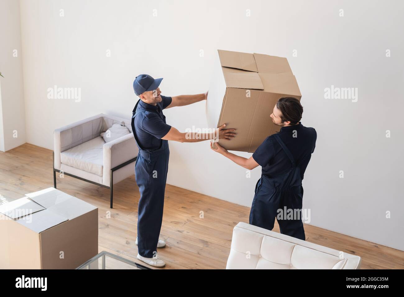 Delivery workers carry boxes hi-res stock photography and images - Alamy