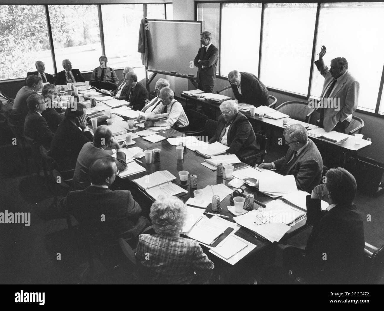 Austin Texas USA, 1990: Members of the board of directors of a professional trade association sit around a conference table and listen to a speaker at their annual meeting. ©Bob Daemmrich Stock Photo