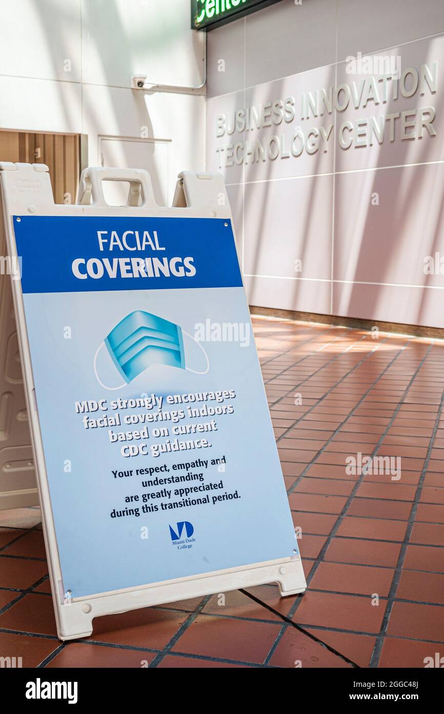 Miami Florida Miami Dade College Wolfson campus sign notice facial coverings mask masks CDC guidance Covid-19 health crisis pandemic coronavirus Stock Photo