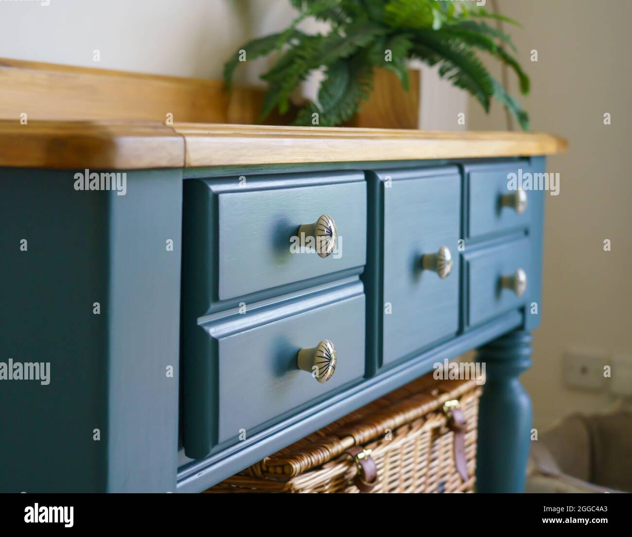 a beautiful hand painted deep blue dresser with finished wooden joinery top Stock Photo