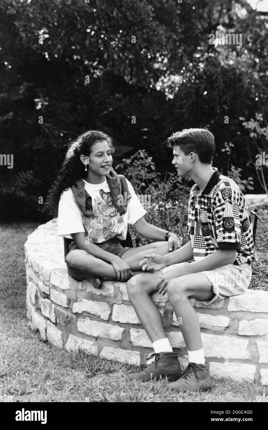 ©1994 Teens talking: Hispanic girl meets boy in city park for a date, Austin, TX  MR EI-0168, 0181,   NEG FILE EI-0307-3 Stock Photo