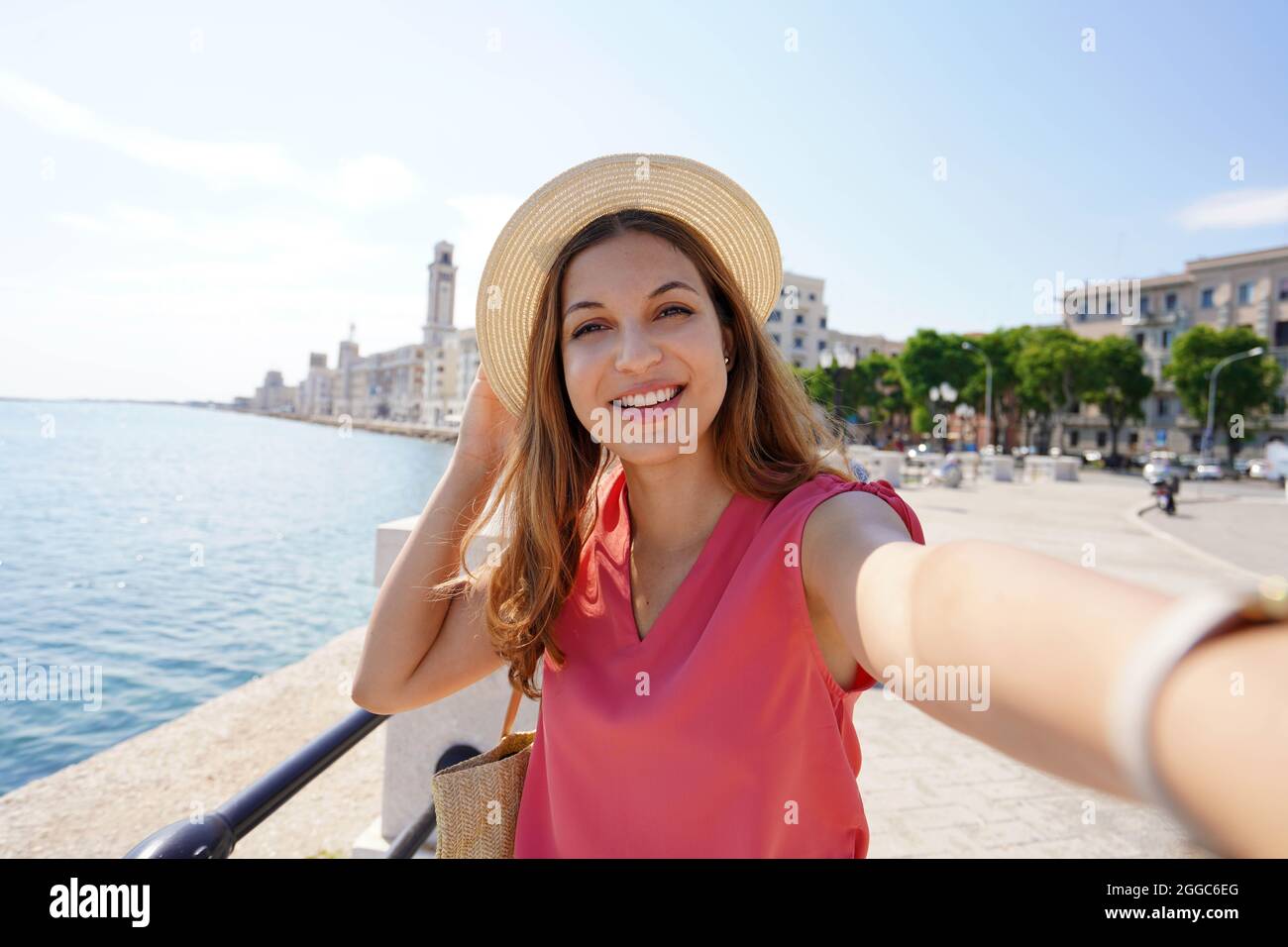 Smiling stylish woman takes self portrait on seaside town of Bari, Apulia, Italy Stock Photo