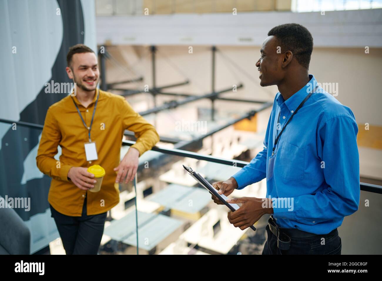 Two managers talking on the balcony in IT office Stock Photo