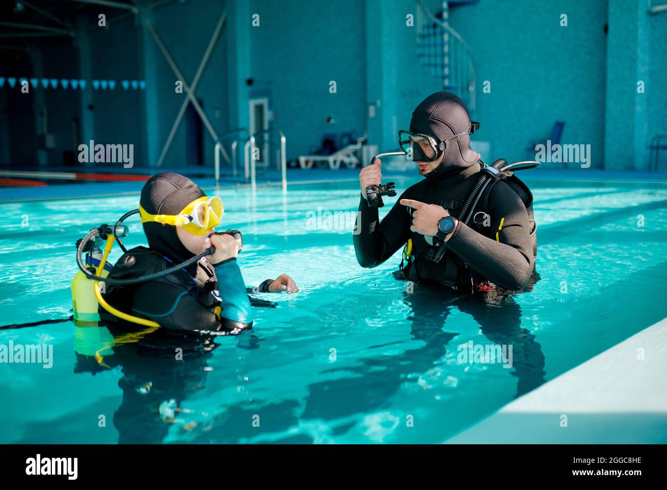 Female diver and male divemaster, diving school Stock Photo