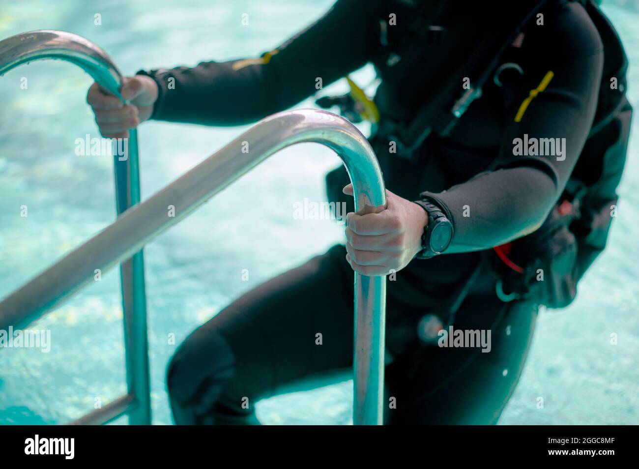 Male diver in scuba gear climb out of the pool Stock Photo - Alamy