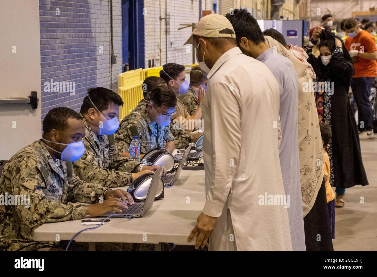 NAVAL STATION ROTA, Spain (Aug. 29, 2021) U.S. Naval Hospital (USNH) Rota Sailors enter the information of evacuees from Afghanistan into the hospital computer system after their arrival at Naval Station (NAVSTA) Rota Aug. 29, 2021. NAVSTA Rota is currently supporting the Department of State mission to facilitate the safe departure and relocation of U.S. citizens, Special Immigration Visa recipients, and vulnerable populations from Afghanistan. (U.S. Navy photo by Mass Communication Specialist 1st Class Nathan Carpenter) Stock Photo