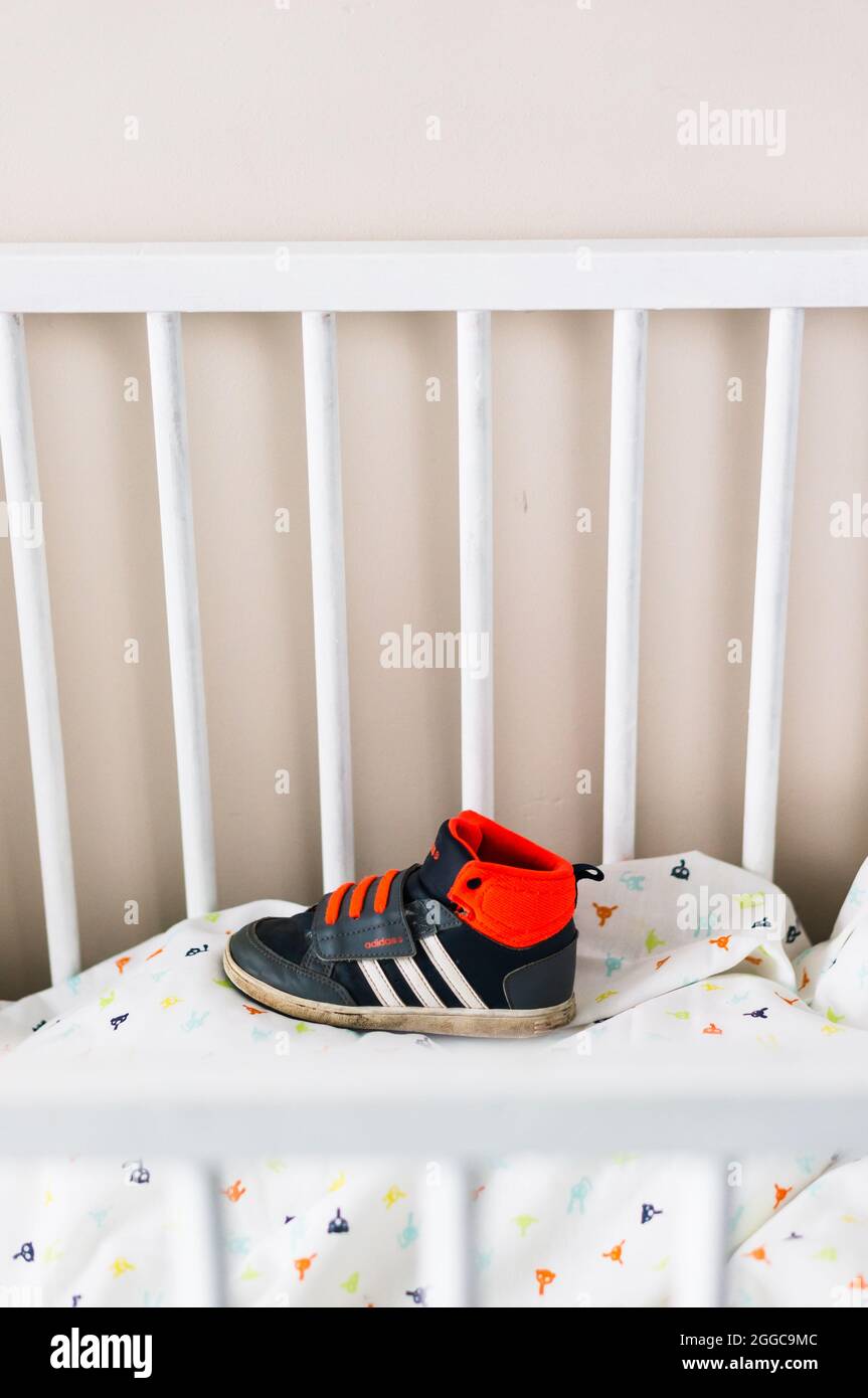 POZNAN, POLAND - Aug 10, 2021: A small child Adidas sports shoe on a bed  sheet Stock Photo - Alamy
