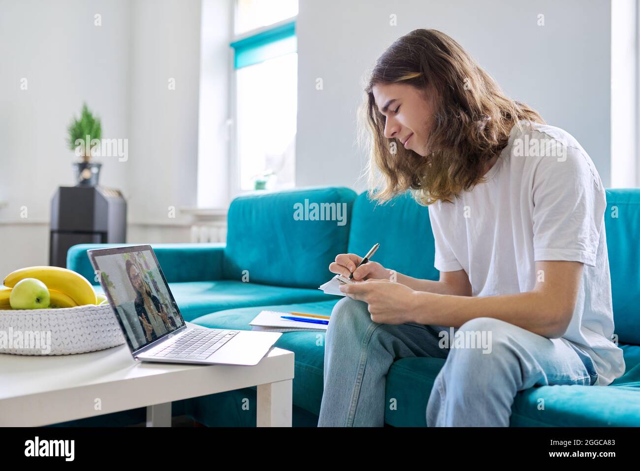 Individual online lesson, teenage boy studying at home with laptop ...