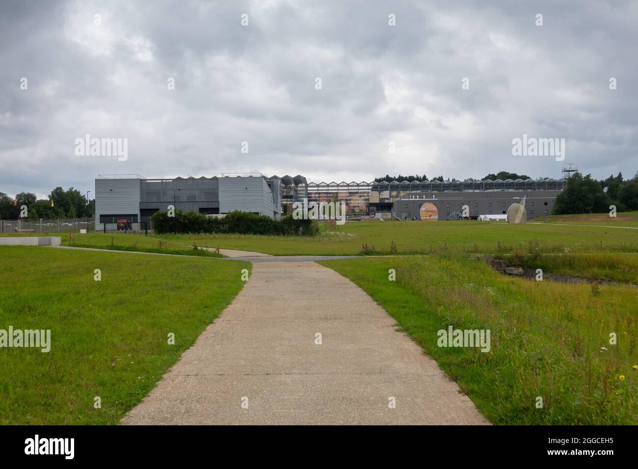 Transinne, Wallonia, Belgium - August 10, 2021: Euro Space Center and Galileo ILS Centre buildings seen from back of green domain under heavy rainy cl Stock Photo