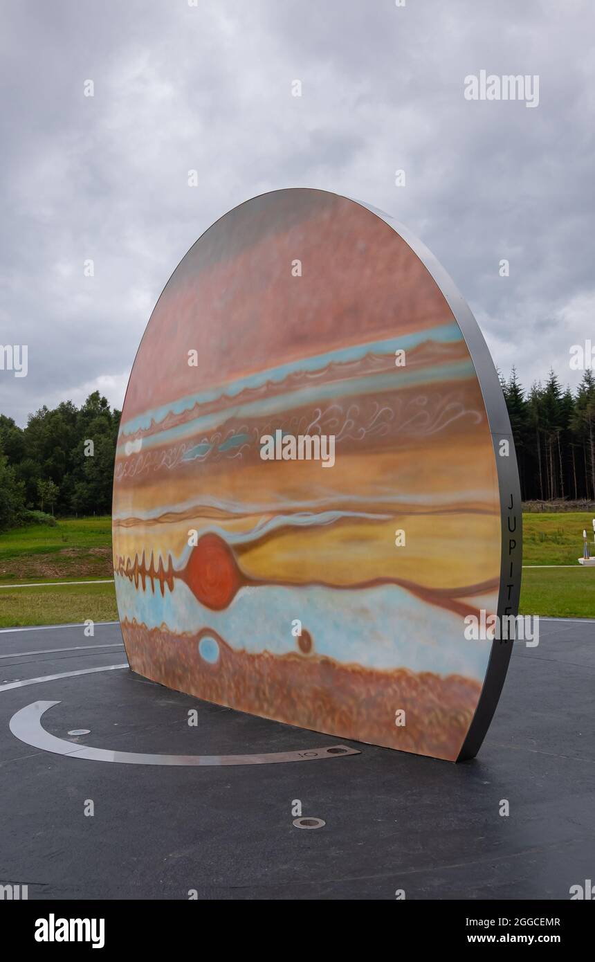 Transinne, Wallonia, Belgium - August 10, 2021: Euro Space Center domain. Portrait of Jupiter Planet colored symbol under rainy cloudscape. Green fore Stock Photo