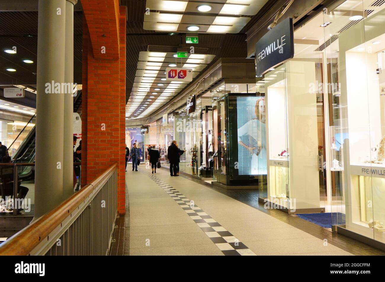 POZNAN, POLAND - Dec 14, 2014: The people walking along stores in the Stary Browar shopping mall in Poznan, Poland Stock Photo