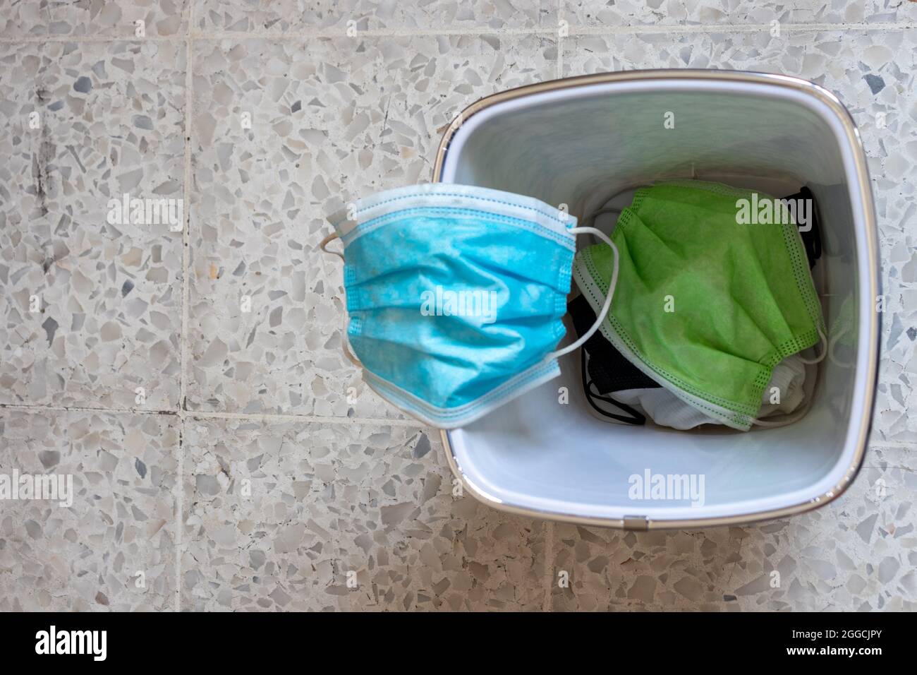 face mask inside a garbage can , end of pandemic concept Stock Photo