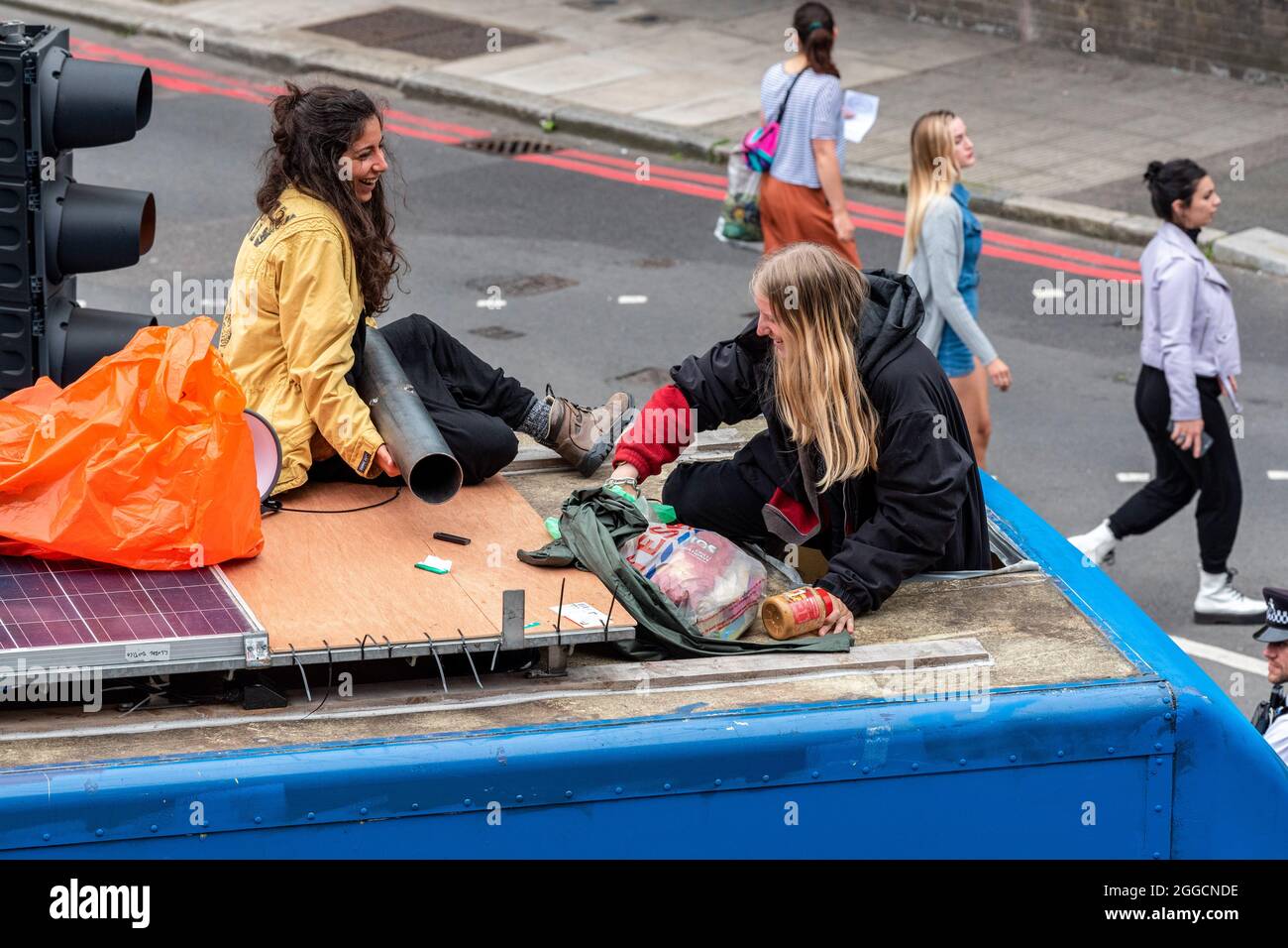 Two Protestors Two protesters are seen on top of a van that was used as part of a road ...