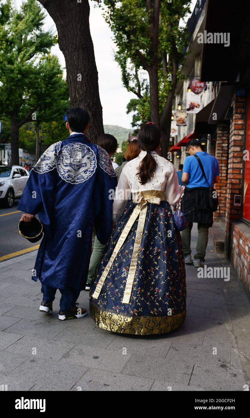 Traditionally dressed couple walking on samcheong-ro in Seoul, Korea. Stock Photo