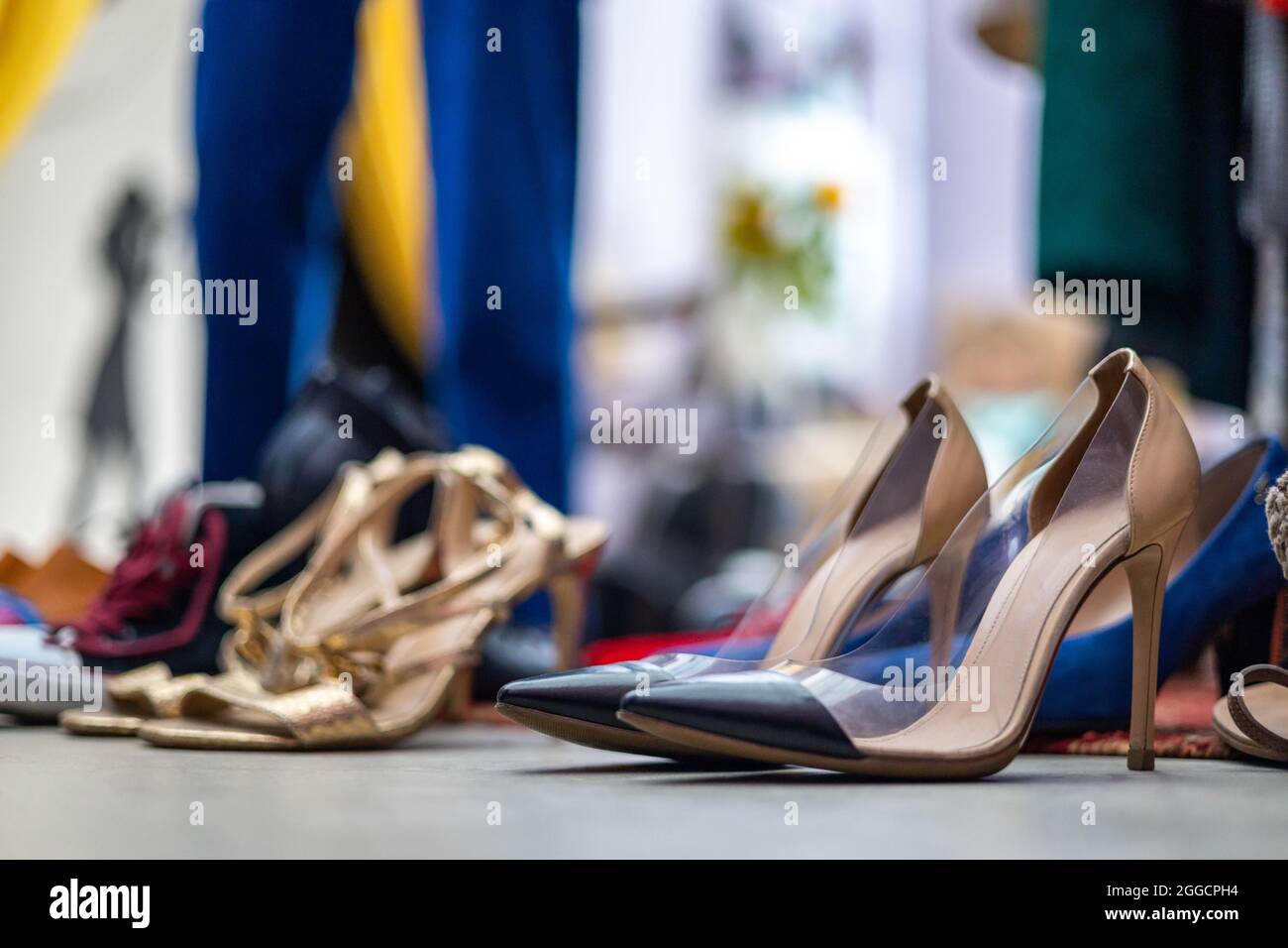 Modern clothes rack full of fashionable apparel and shoes closeup clothing and accessories storage Stock Photo