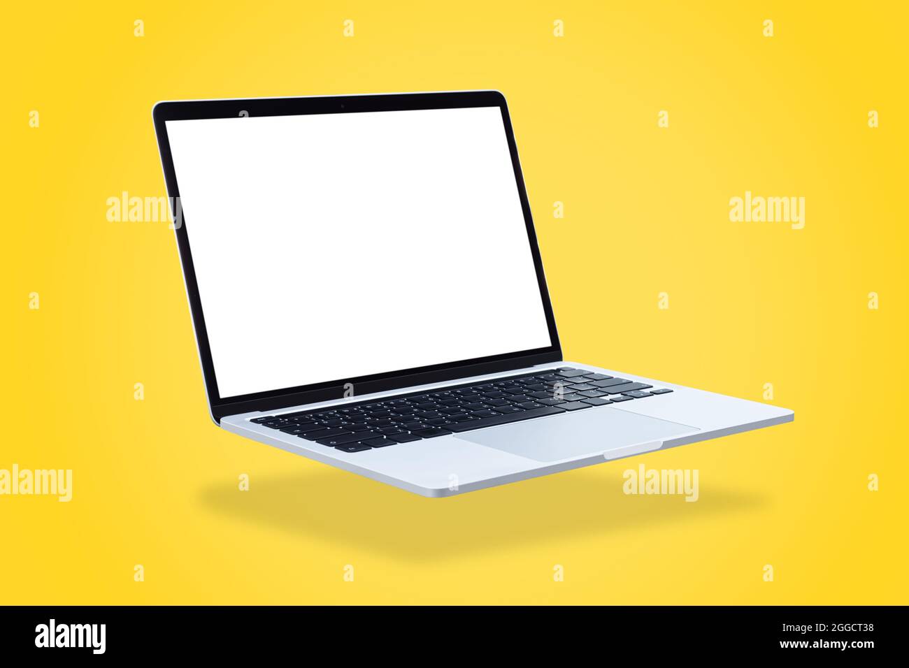 Laptop computer with blank screen, floating on a yellow background. Stock Photo