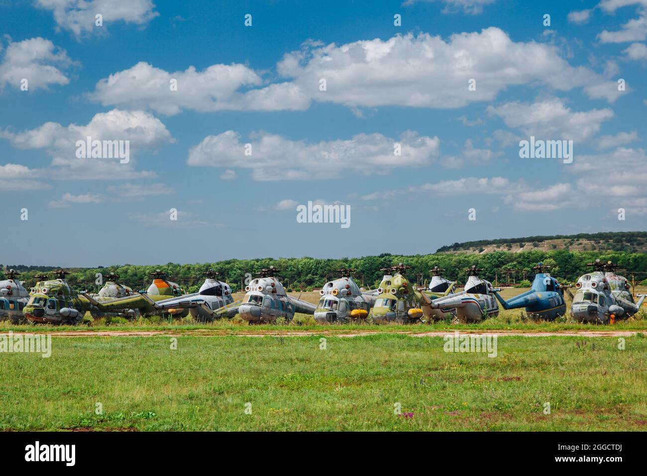 Old abandoned helicopters, broken non-working helicopters, cemetery of old helicopters. Stock Photo