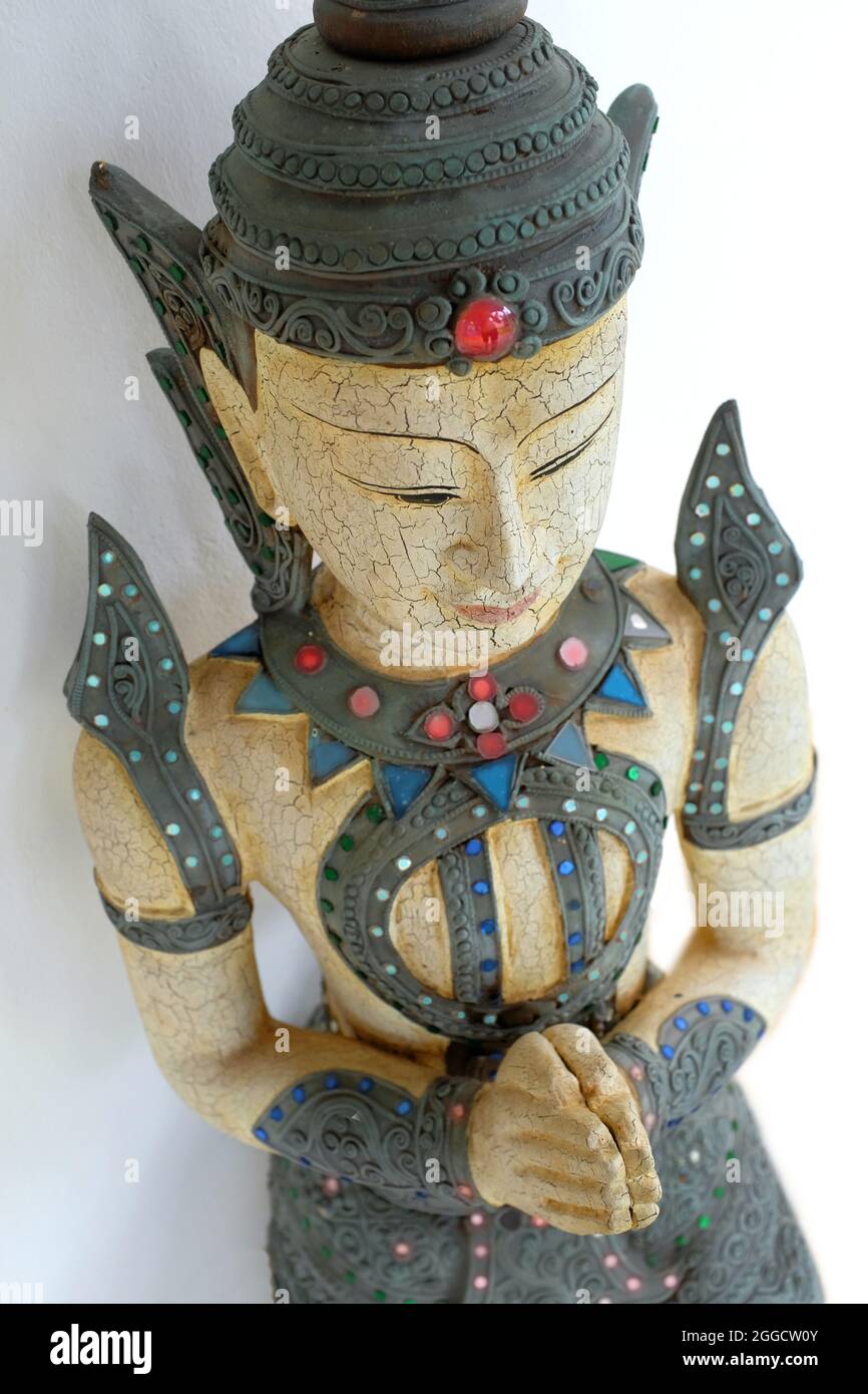 A Thai figure of Deva giving the Thai greeting of clasped hands. Stock Photo