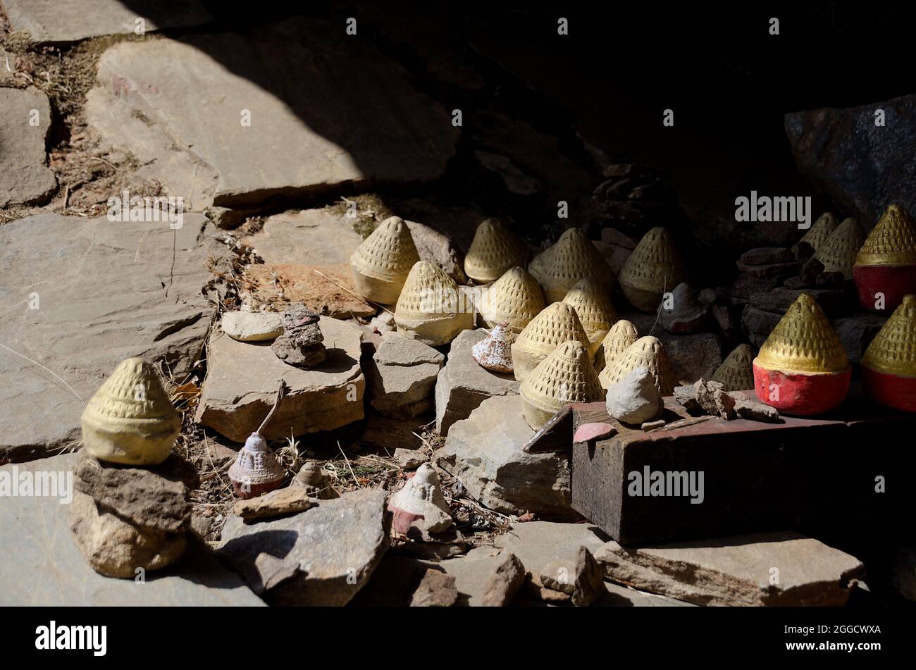 Collection of Tsa-Tsas: clay votives in the shape of cylindrical cones or stupas, placed along the Paro Taktsang (Tiger Nest's) trail, Bhutan Stock Photo